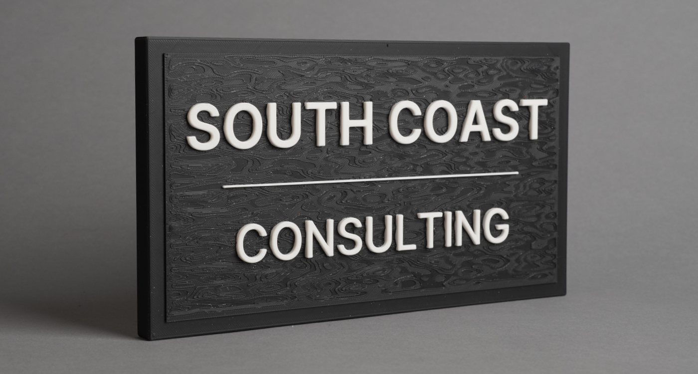 3D printed desk sign with raised lettering for a consulting business